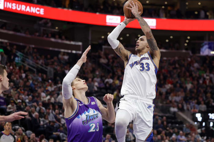 Dec 22, 2022; Salt Lake City, Utah, USA; Washington Wizards forward Kyle Kuzma (33) shoots the ball over Utah Jazz forward Lauri Markkanen (23) during the second half at Vivint Arena. Mandatory Credit: Chris Nicoll-USA TODAY Sports